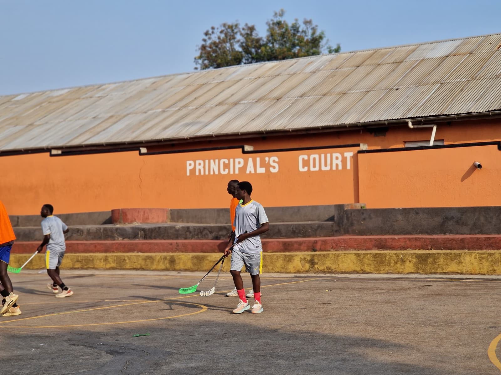 Floorball players warming up on a school court