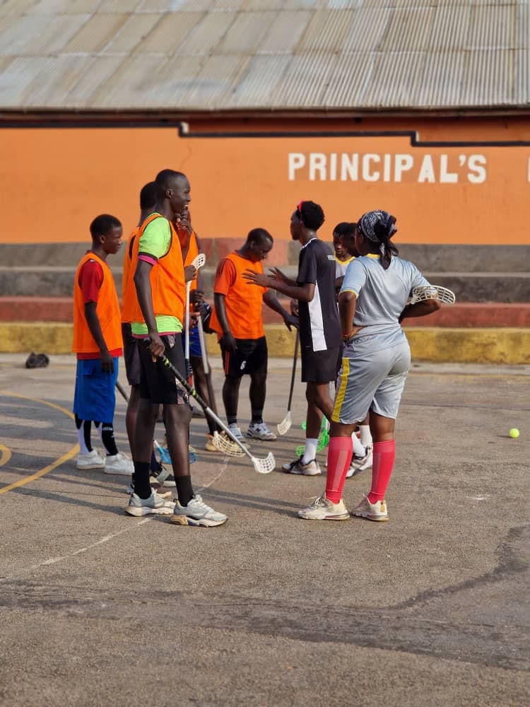 Coach briefing players during a floorball clinic